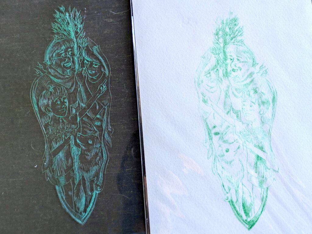 An plexi drypoint print in green ink is etched in a black and white fabric.