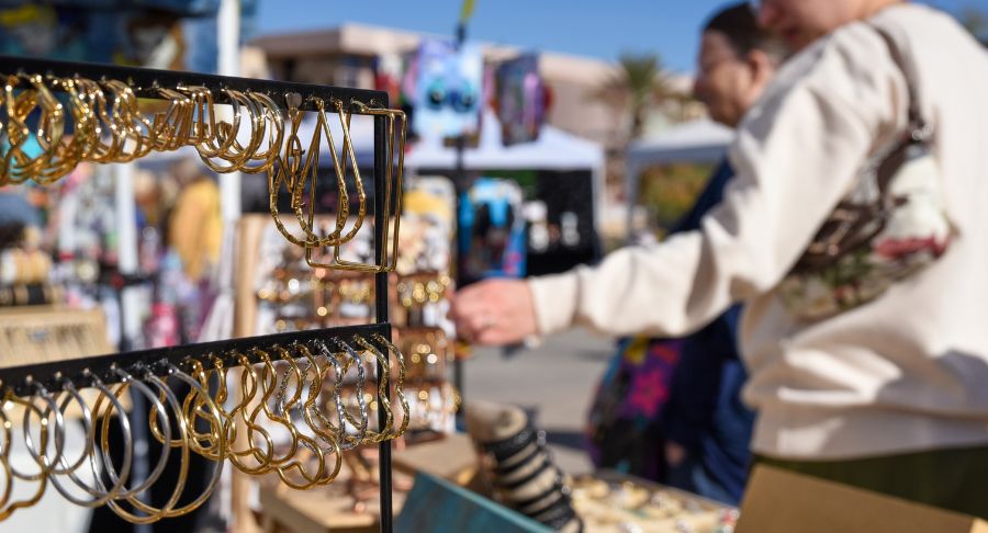 Earrings in the foreground, while shoppers looks are other merchandise