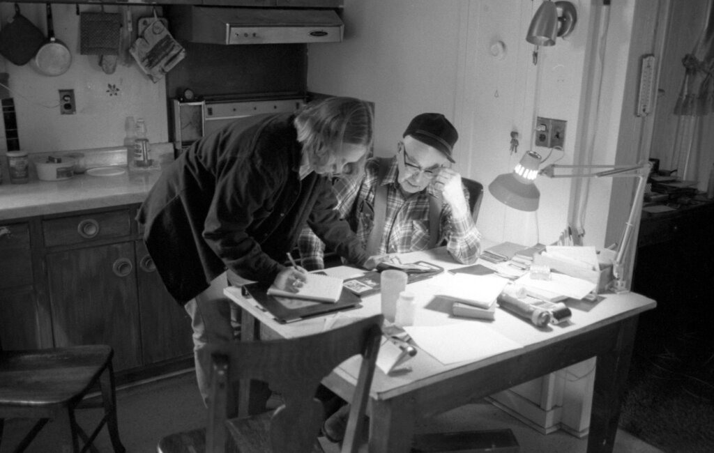 Frequently, interviews require checking notes with your interviewees, like in this 1988 picture of Andrea Graham with Doc Allen.