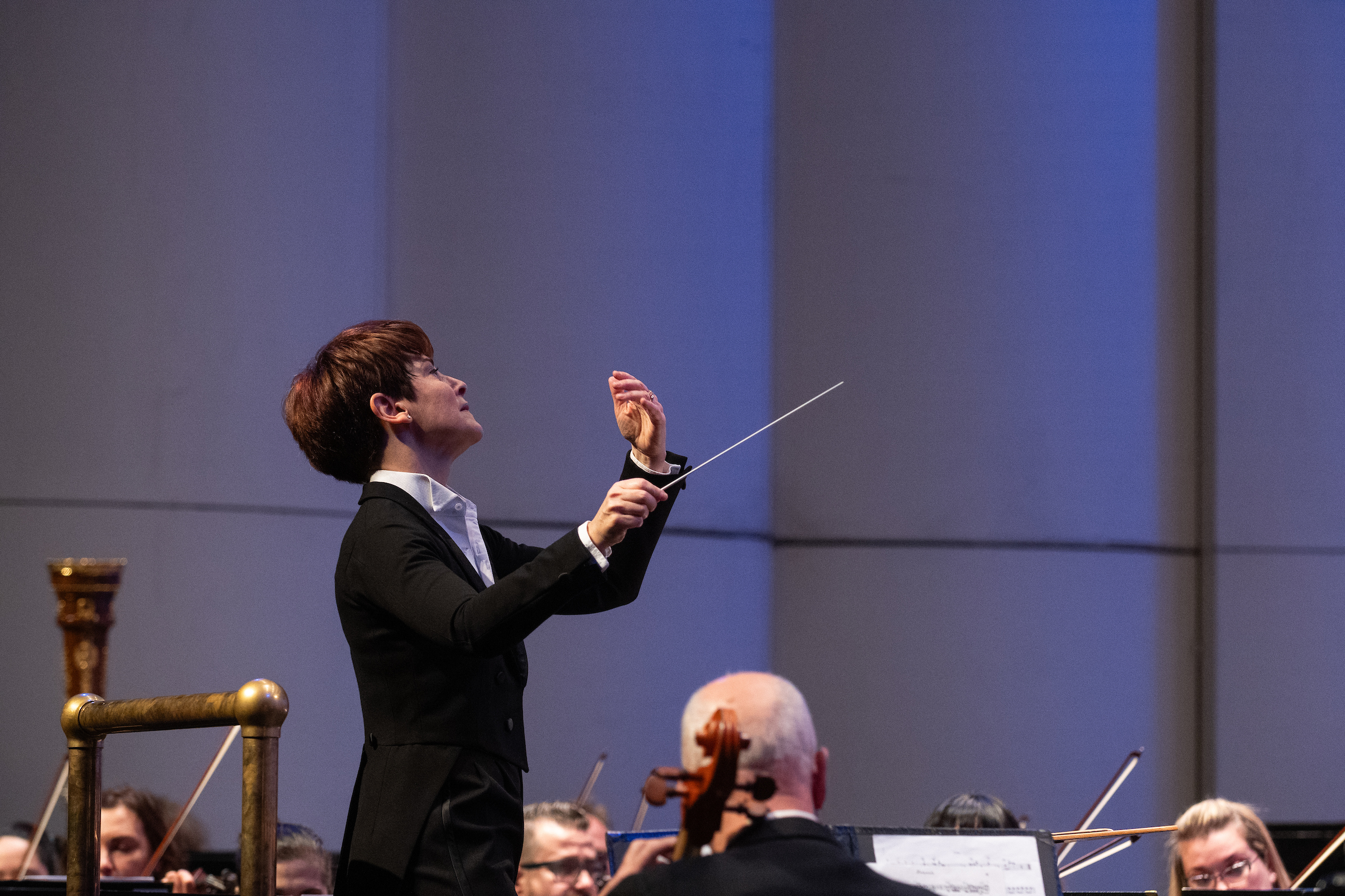 A conductor gestures during a performance.