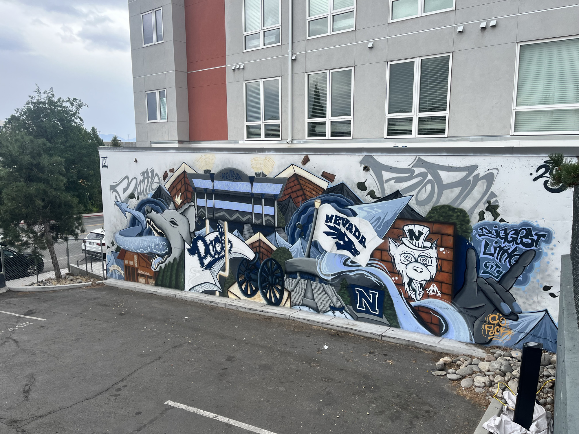Large scale outdoor freestyle mural painted in a University of Nevada, Reno theme.