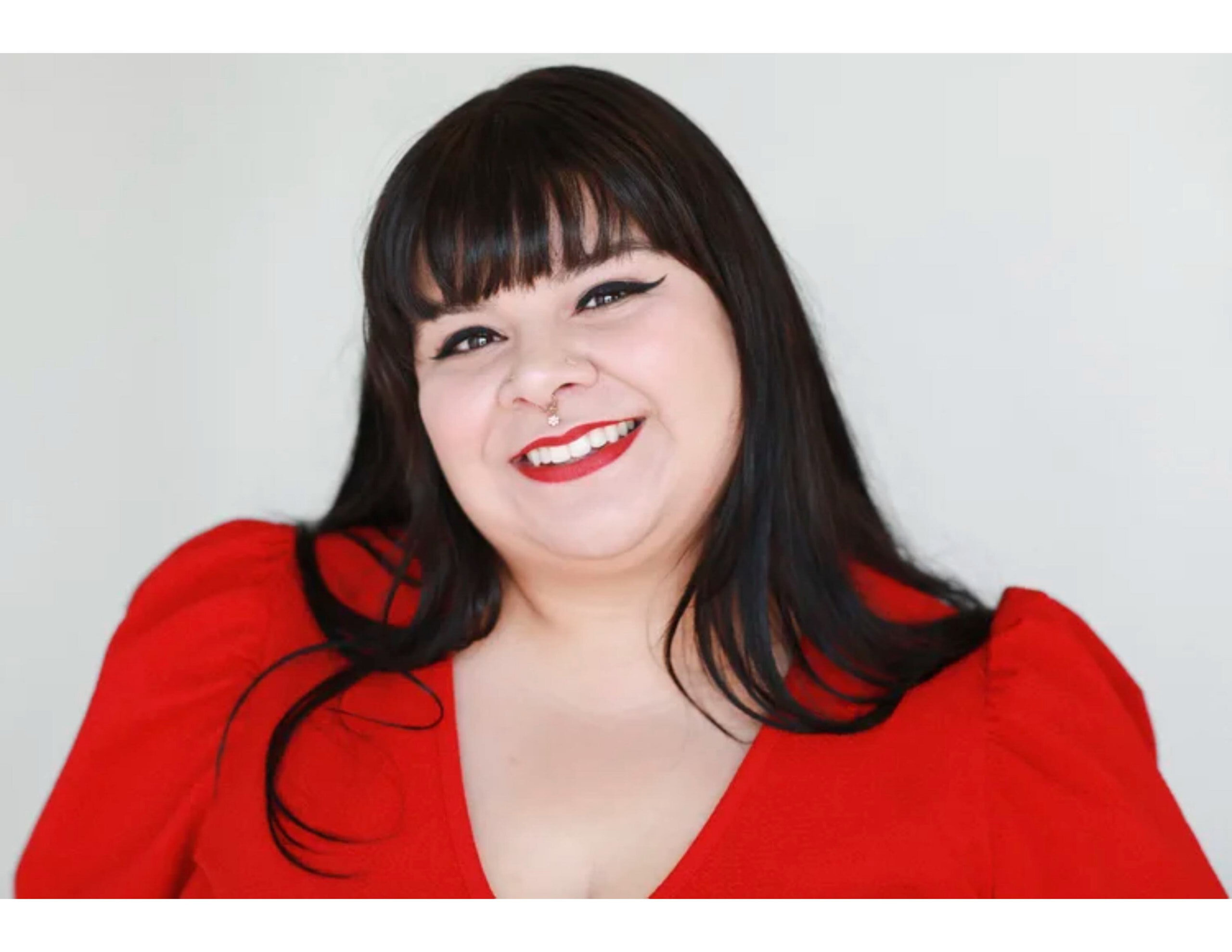Headshot of Elisa Garcia wearing a red top
