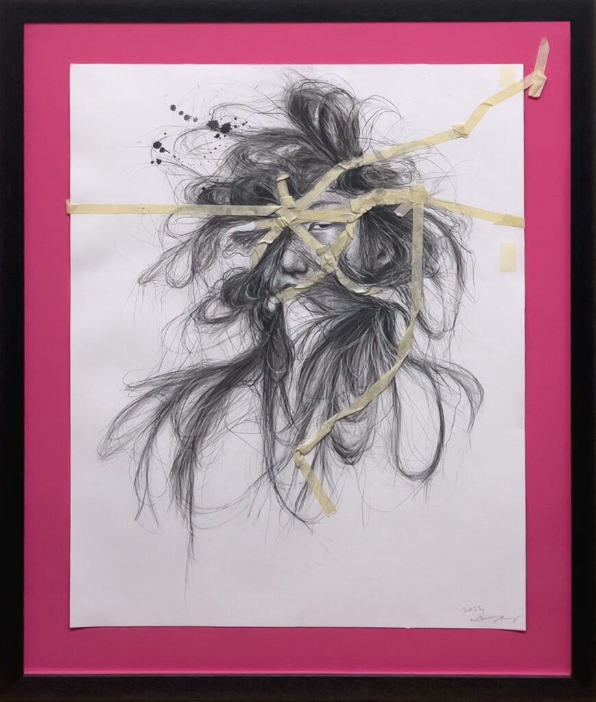 A pencil drawing of a face with wild, flowing hair on white paper is taped with masking tape in angular lines, displayed on a bright pink background within a black frame.