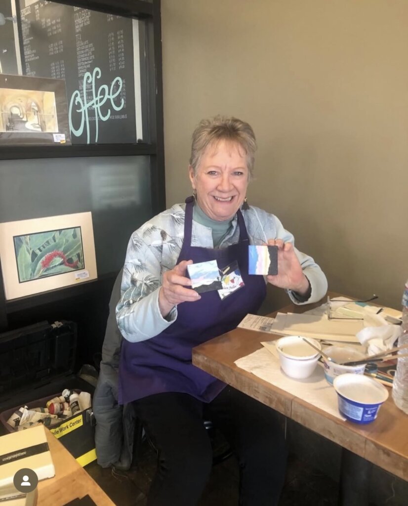 Eileen Fuller holds some of her works
