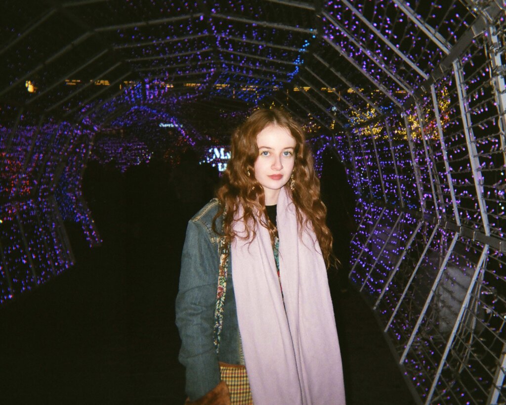Regan Margetts in a tunnel with string lights