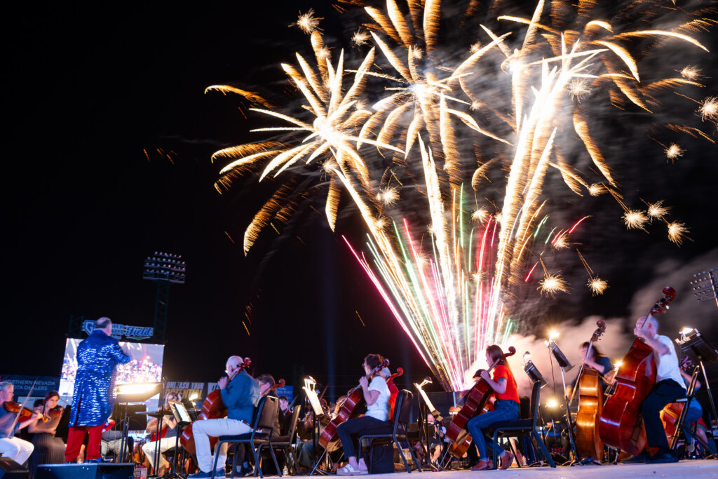 Fireworks over crowd at baseball field