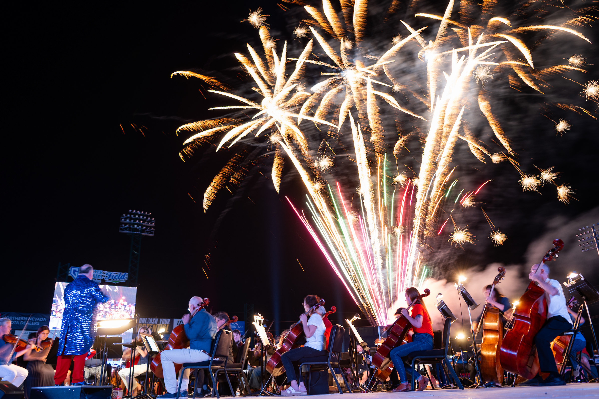 Fireworks over crowd at baseball field