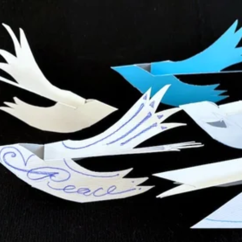 Paper birds with messages written on them.