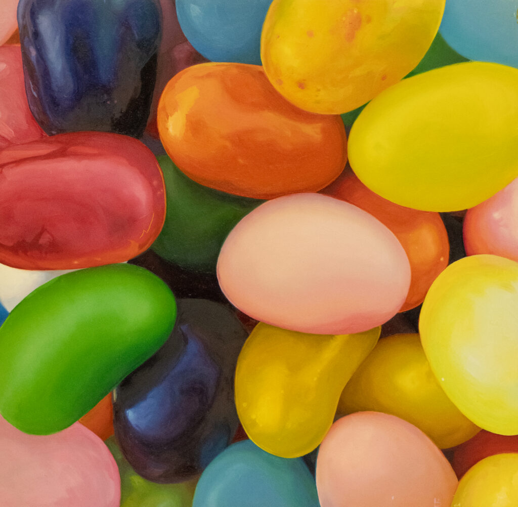 A colorful assortment of jelly beans in various bright colors, including yellow, orange, green, pink, red, blue, and purple, filling the entire frame.