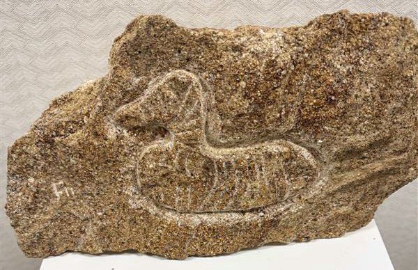It's a carving of a tule duck decoy, Nevada's state artifact! It's one of the Nevada Tartan Stones, a series of stone carvings you can see at the Nevada State Library and Archives in Carson City. 