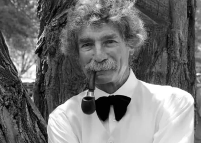 Black and white Portrait of Mark Twain Impersonator smoking a pipe