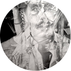 A circular, black and white abstract image shows overlapping layers of a person’s face and upper body, adorned with jewelry, blending with various shapes and light textures. The composition creates a surreal, dreamy effect.